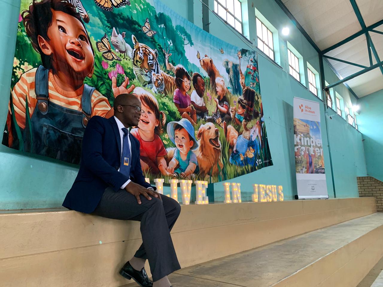 Director with Educational Mural